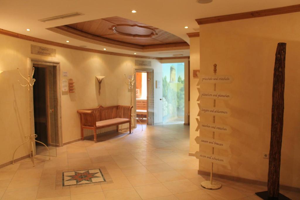 a hallway with a room with a table and a floor at Garden & SPA Hotel Das Götzfried in Regensburg