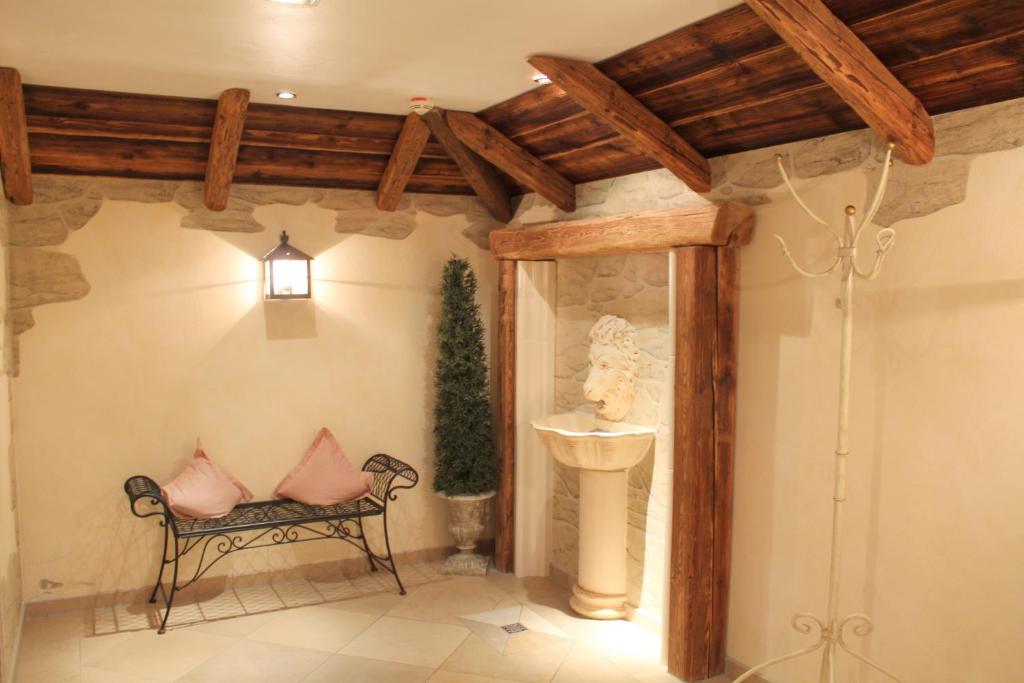 a room with a bench with two pillows on it at Garden & SPA Hotel Das Götzfried in Regensburg