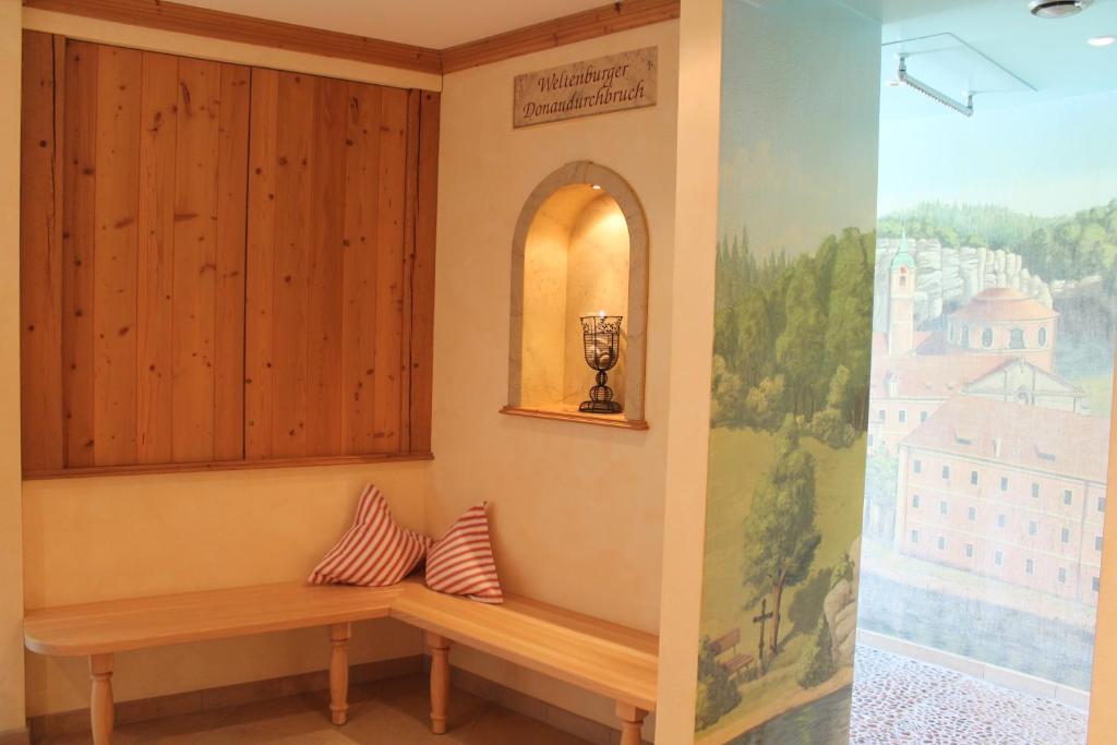 a bench in a room with a painting on the wall at Garden & SPA Hotel Das Götzfried in Regensburg