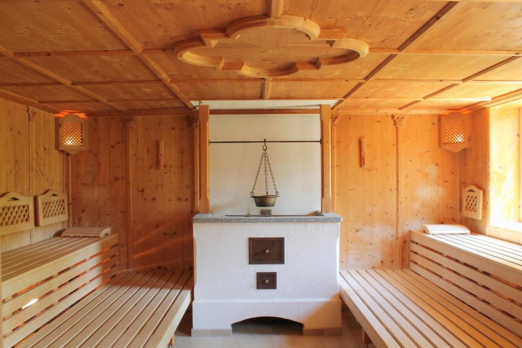 an empty room with a stove in a wooden house at Garden & SPA Hotel Das Götzfried in Regensburg