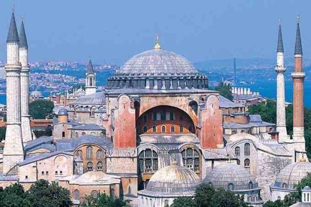 a large building with two mosques in a city at Fatih Econo Apart in Istanbul