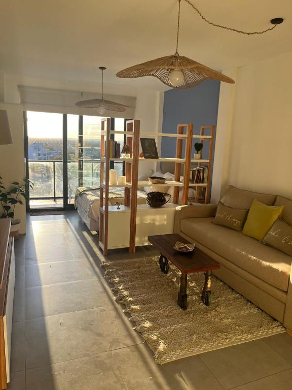 a living room with a couch and a table at Ministro Brin Suite MT in Remedios de Escalada