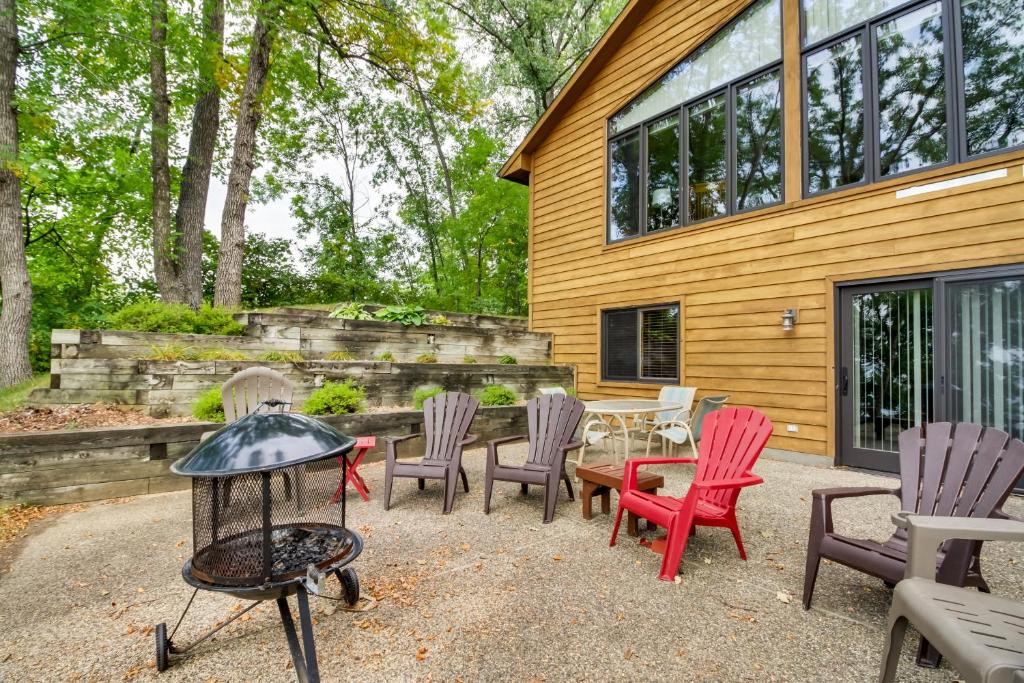 a group of chairs and a table in front of a house at Lakefront Home with Beach, Deck and Fire Pit! in Alexandria