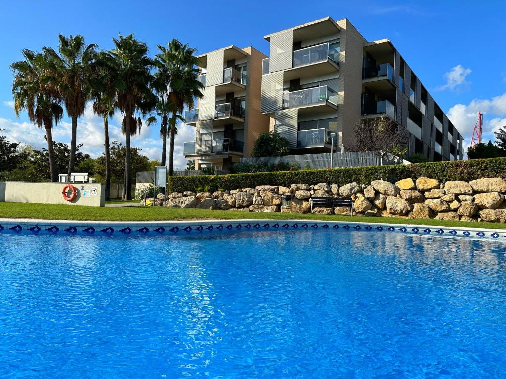 a large swimming pool in front of a building at Domuum Holidays - PARADISE VILLAGE in Salou