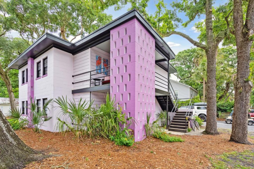 a pink house with a black roof at Folly Vacation Great Location, Vintage and Fun 120 Unit A in Folly Beach