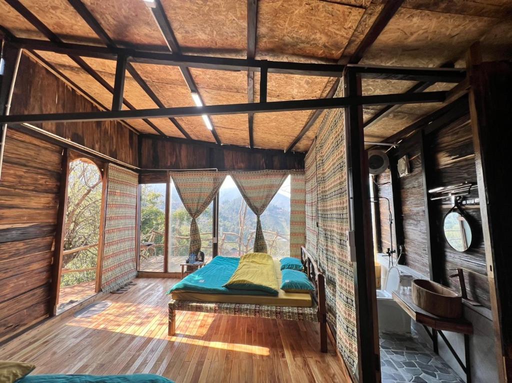- une chambre dans une cabane dans les arbres avec un lit dans l'établissement Mando Homestay, à Bắc Yên