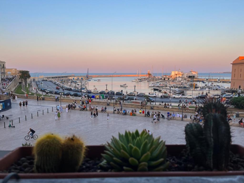 a group of people walking around a city with a harbor at Una finestra sul mare in Bari