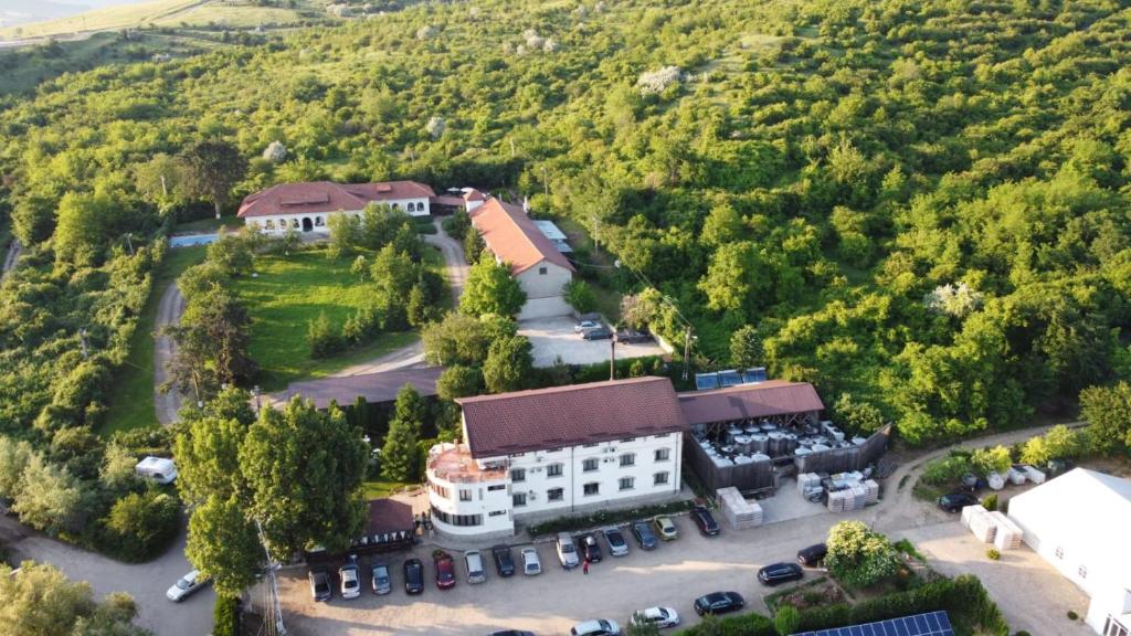 an aerial view of a building with a parking lot at Casa Colinelor in Urlaţi