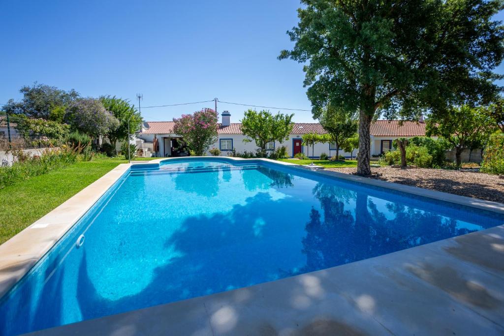 a swimming pool in the yard of a house at Tia Antonia 