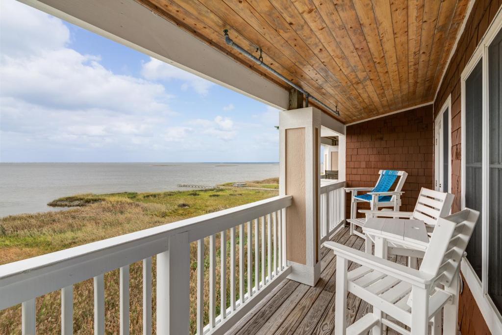 a porch with two chairs and a table and a view of the ocean at C309 - Sounds Good 309 in Nags Head