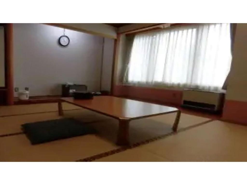 a living room with a coffee table and a window at Asakusa Sanso - Vacation STAY 51996v in Uonuma