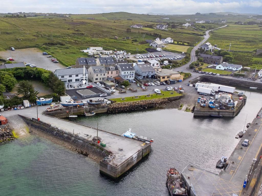 an aerial view of a harbor with a boat in the water at Cleggan Pierside Apt 1 in Cleggan