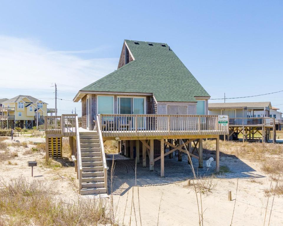 a house with a deck on the beach at 7026 - Southwind by Resort Realty in Rodanthe