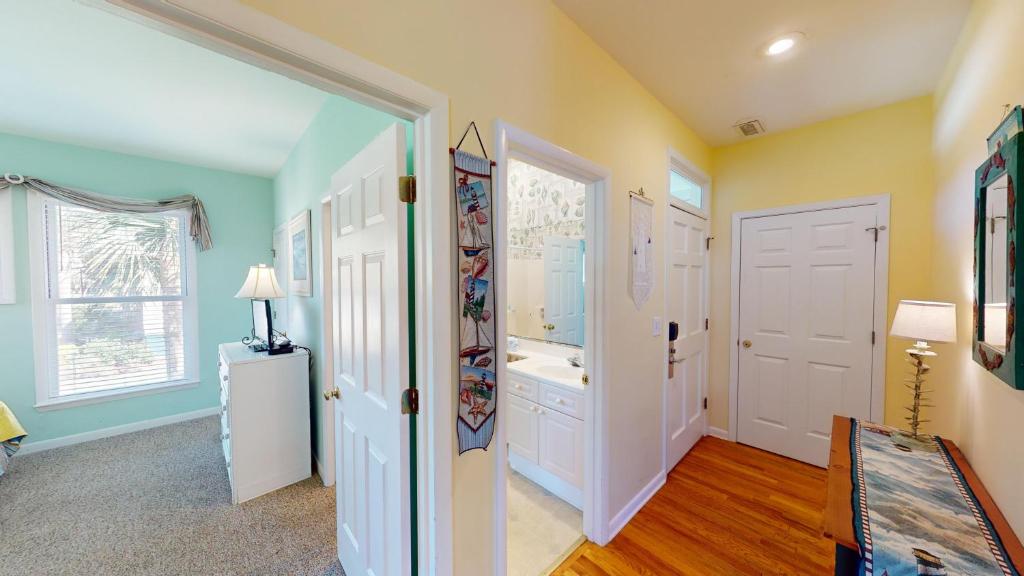 a bathroom with a tub and a sink in a room at Beautiful 2BR 2BA Lakeside Villa with Lake Views in Pawleys Island