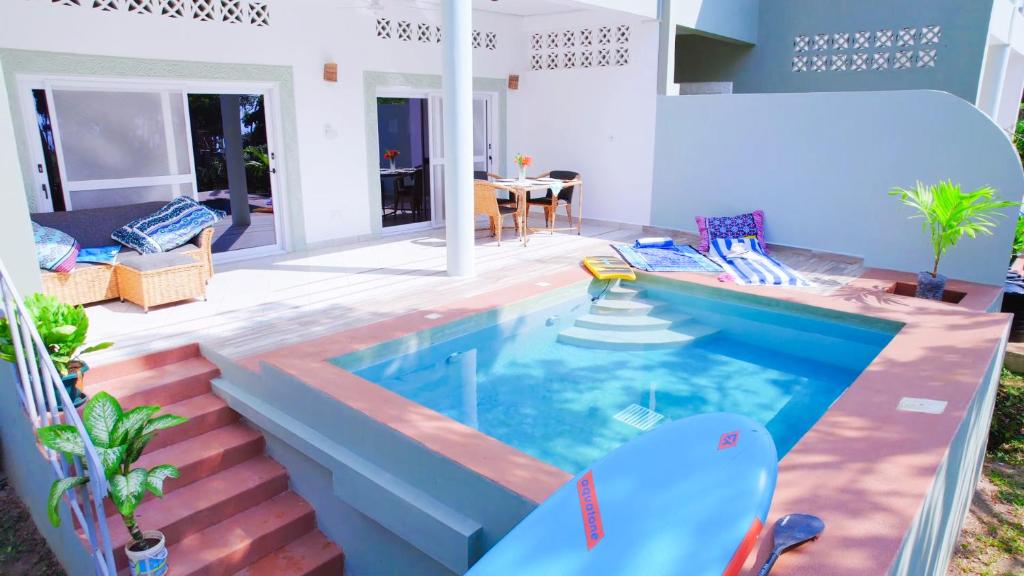 a swimming pool in the middle of a house at The Pool House & The Colobus House, Bella Seaview, Diani Beach, Kenya in Diani Beach