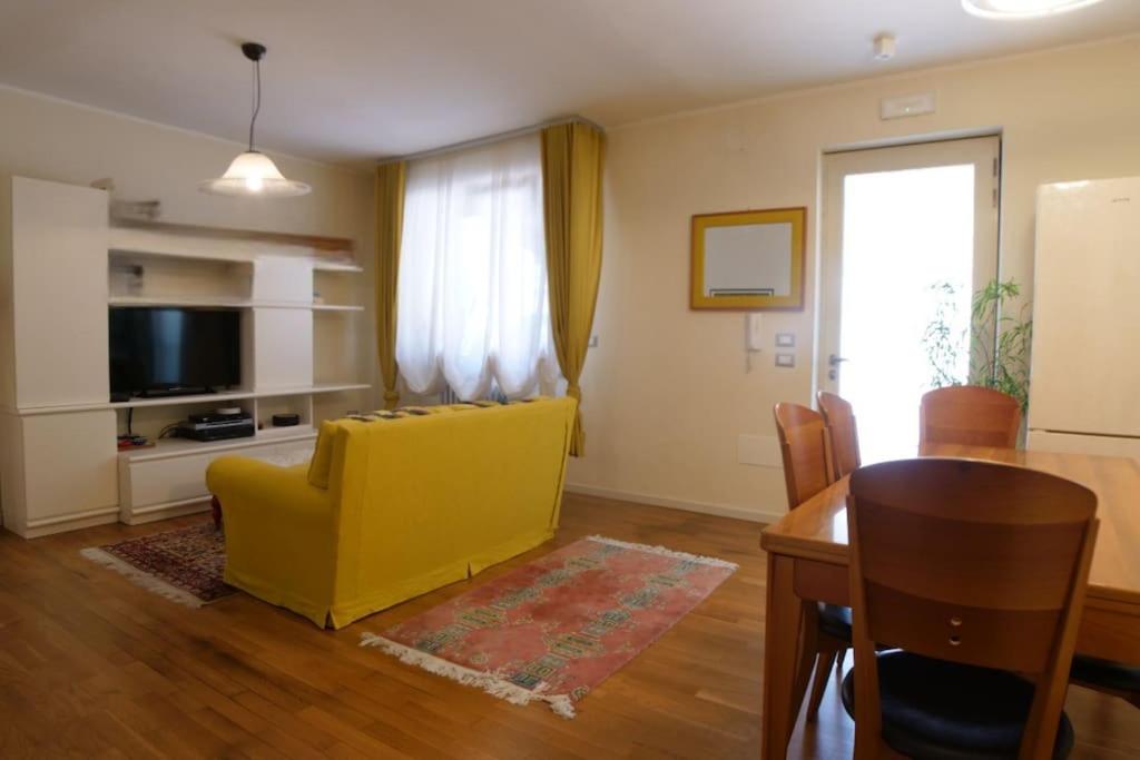 a living room with a yellow couch and a table at Appartamento da Paola in Pescara