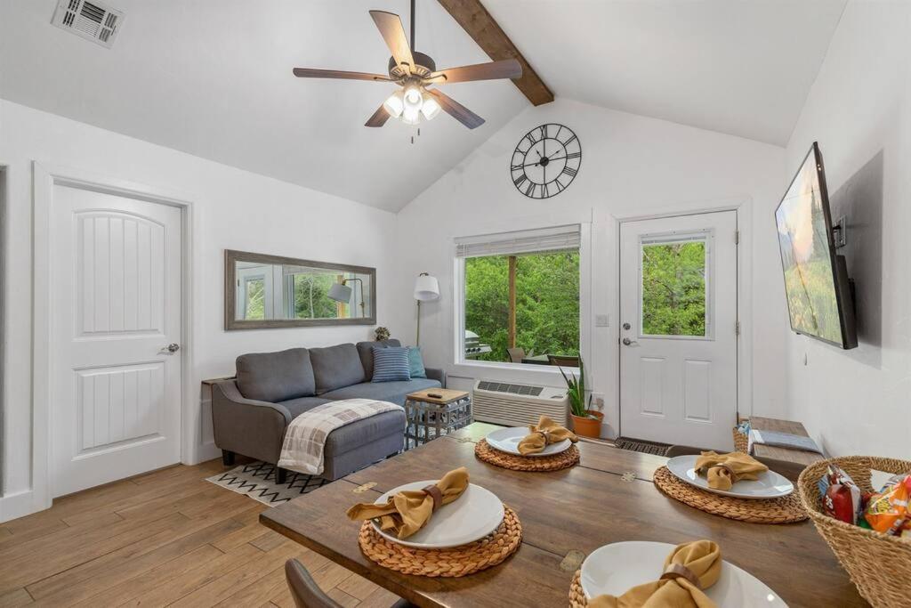 a living room with a couch and a table at Cozy Cottage • 2 King Beds • Grove • Kayaks • Washer/Dryer in Grove