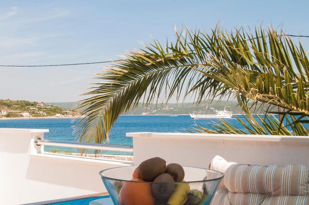 a bowl of fruit on a table with a view of the ocean at Apartment Ivan in Drvenik Mali