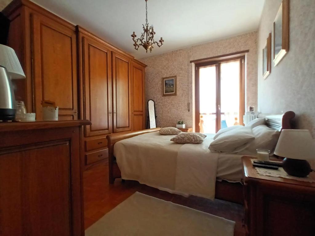 a bedroom with a large bed and a window at In Famiglia in Biella