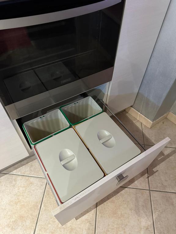 a drawer of an oven with four controllers in it at La tana di Piozzo in Piozzo