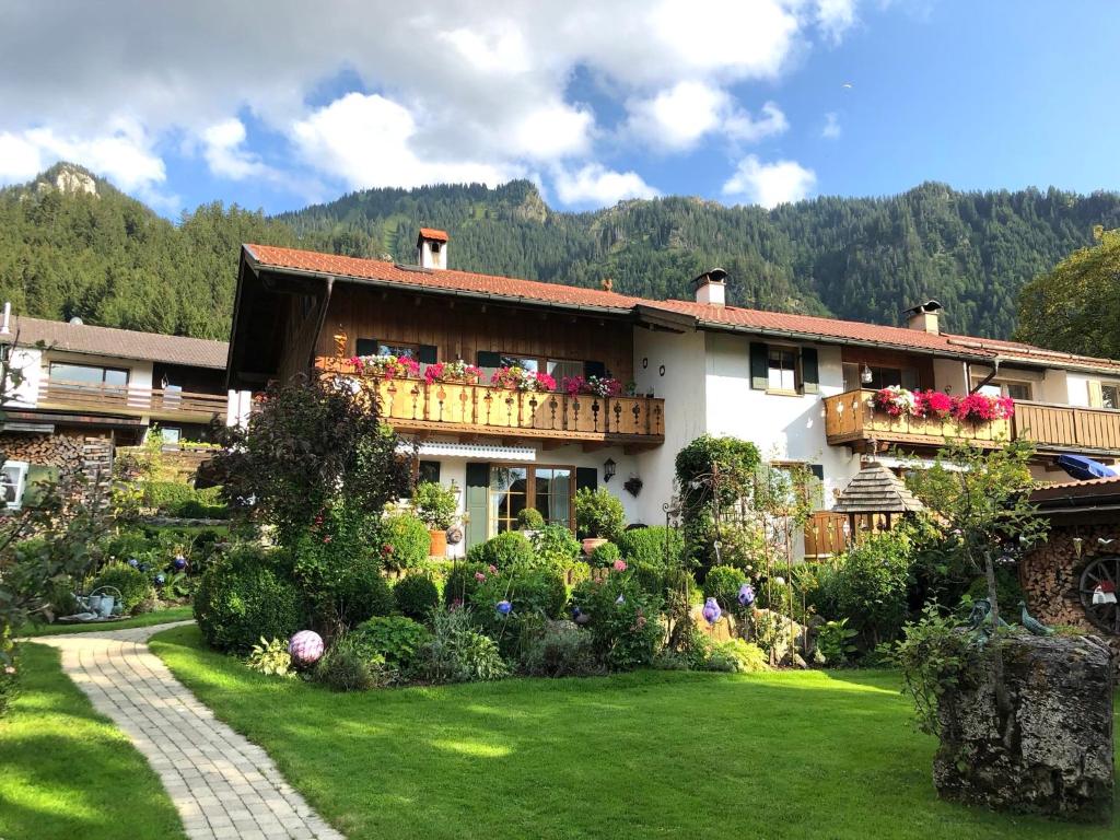 a large house with a garden in front of it at Ferienwohnung Mitteldorf in Oberammergau