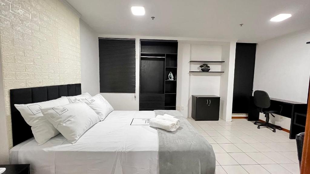 1 dormitorio con 1 cama blanca grande y piano en Flat em Aguas Claras - Brasília - MADB1005 en Águas Claras