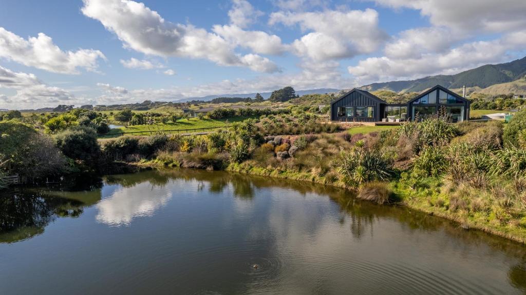 a view of a river in front of a house at Ono in Te Horo