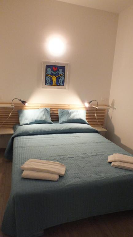 a bedroom with a bed with two towels on it at My Bnb Pisa in Pisa