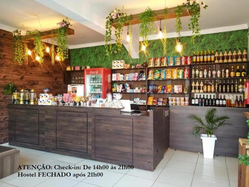 a restaurant with a counter with bottles of alcohol at Elô Hostel in Brasilia