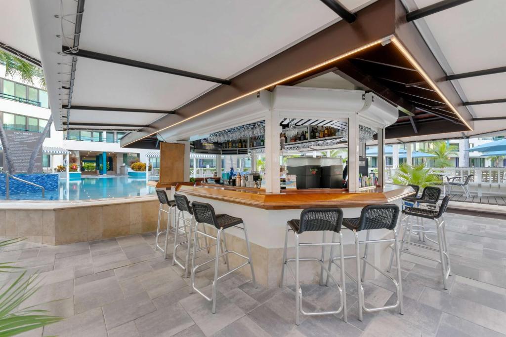 a bar in a resort with chairs and a pool at Hilton Vacation Club Royal Palm St Maarten in Simpson Bay