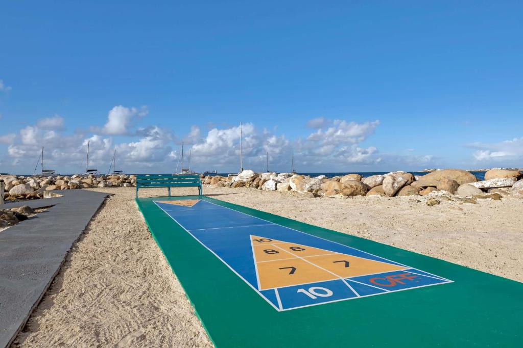 a volleyball court on a beach with rocks at Hilton Vacation Club Royal Palm St Maarten in Simpson Bay
