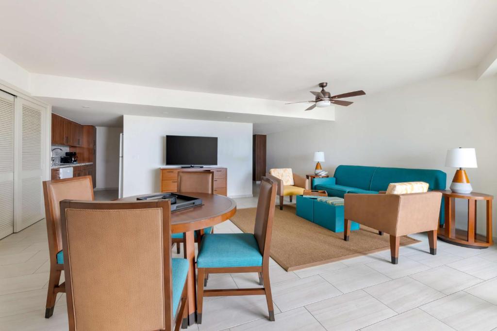 a living room with a table and a blue couch at Hilton Vacation Club Royal Palm St Maarten in Simpson Bay