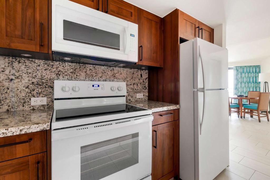 a kitchen with a white stove and a refrigerator at Hilton Vacation Club Royal Palm St Maarten in Simpson Bay