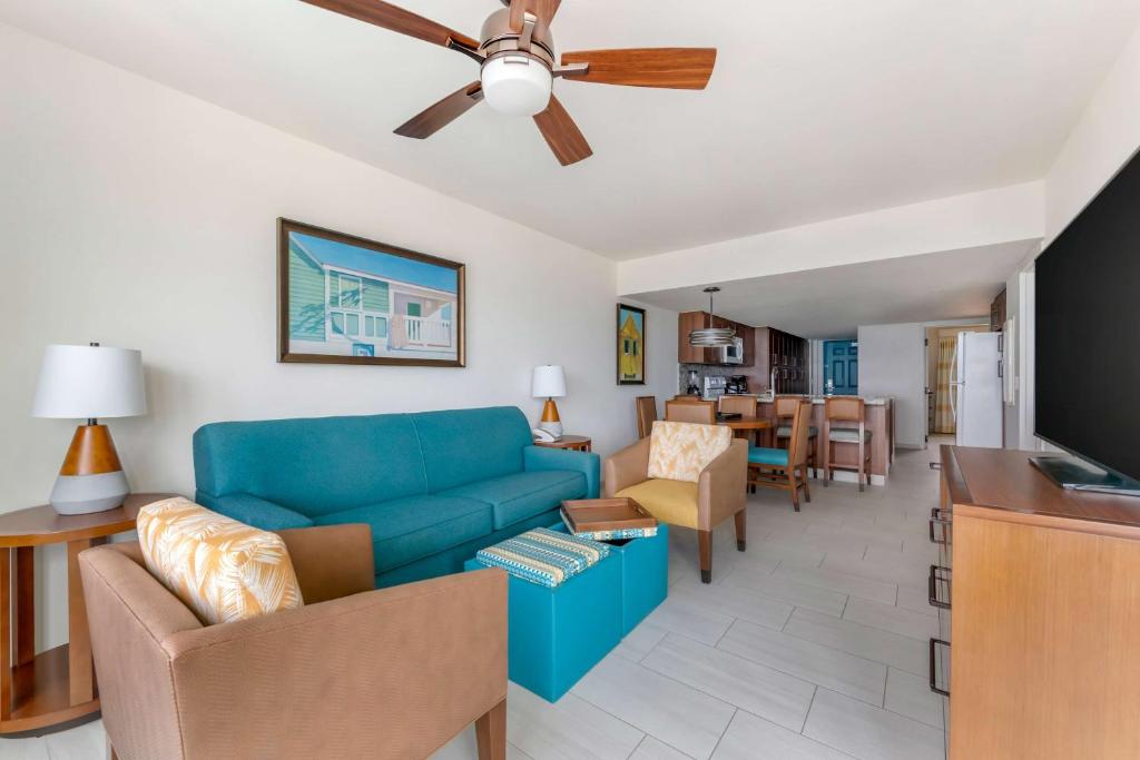a living room with a blue couch and a dining room at Hilton Vacation Club Royal Palm St Maarten in Simpson Bay