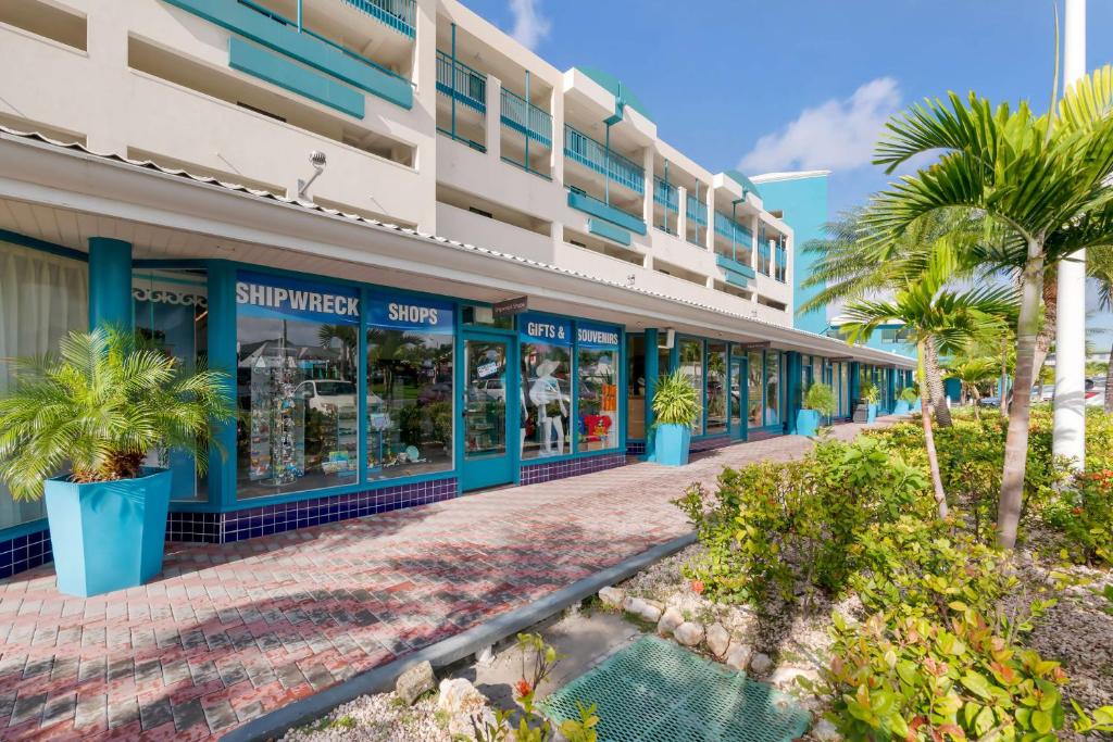 a building with palm trees in front of it at Hilton Vacation Club Royal Palm St Maarten in Simpson Bay