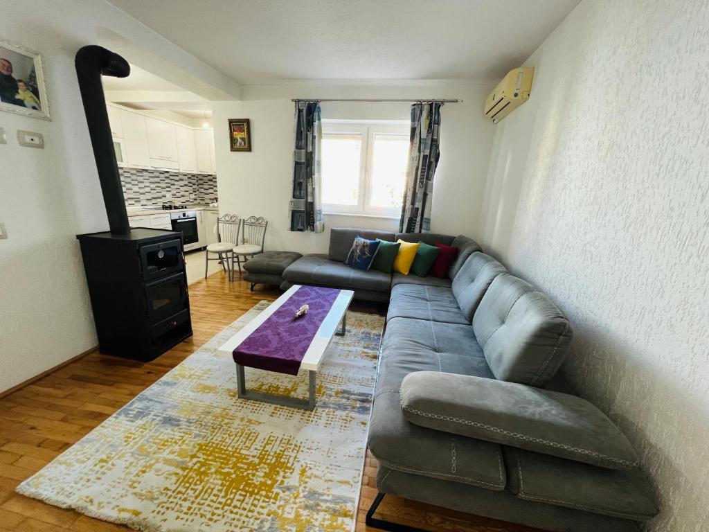 Kukes Apartment Hotel في Kukës: غرفة معيشة مع أريكة وطاولة قهوة