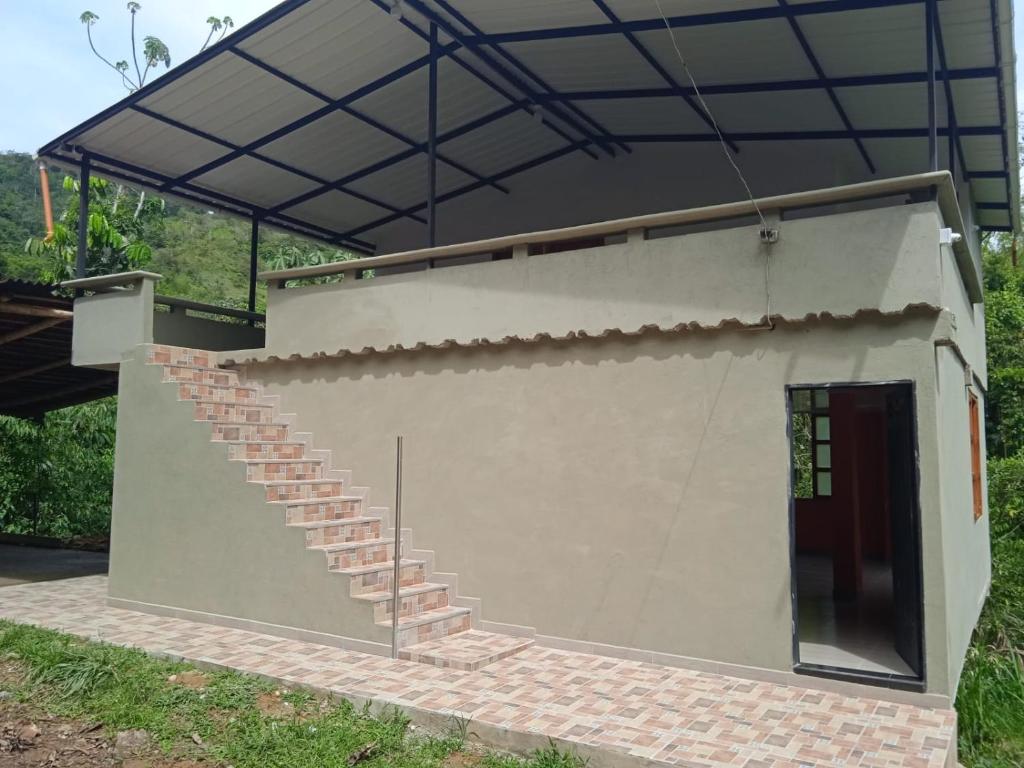 a small building with a staircase and a black roof at Paraíso Escondido in San Rafael