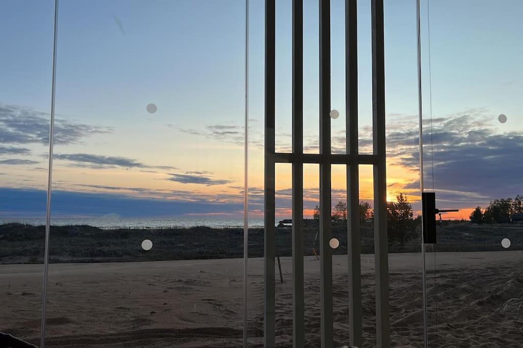a gate with the sunset in the background at Marina Sunset Resort A2 in Kalajoki