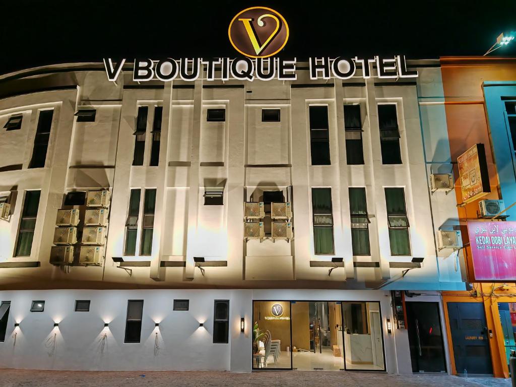 a building with a hotel sign on top of it at V Boutique Hotel Seremban in Seremban