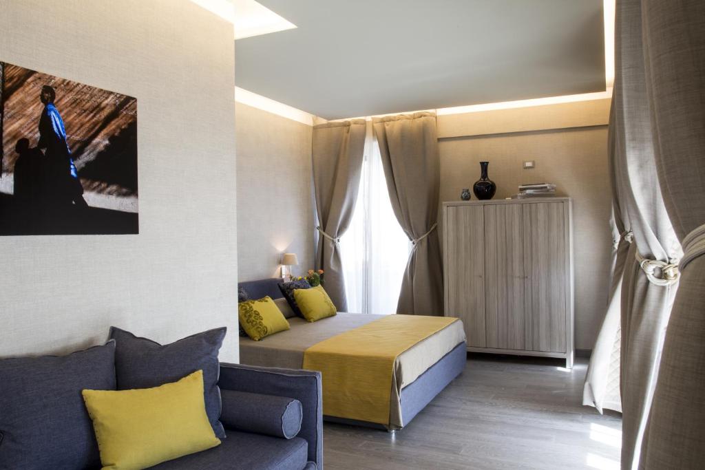 a small bedroom with a bed and a couch at theBed in Pescara