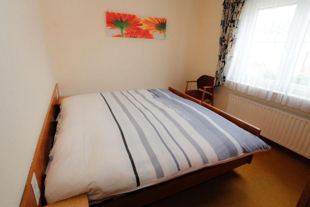 a bed sitting in a bedroom with a window at Meyer Appartments in Beaufort