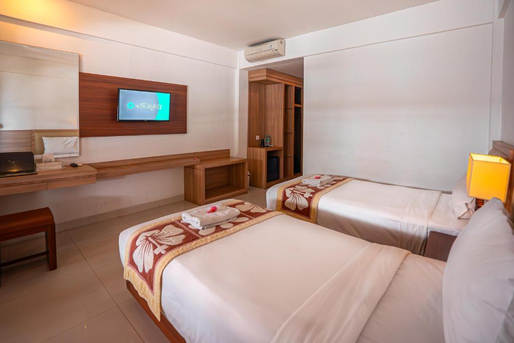 Postel nebo postele na pokoji v ubytování Bali Summer Hotel by Amerta