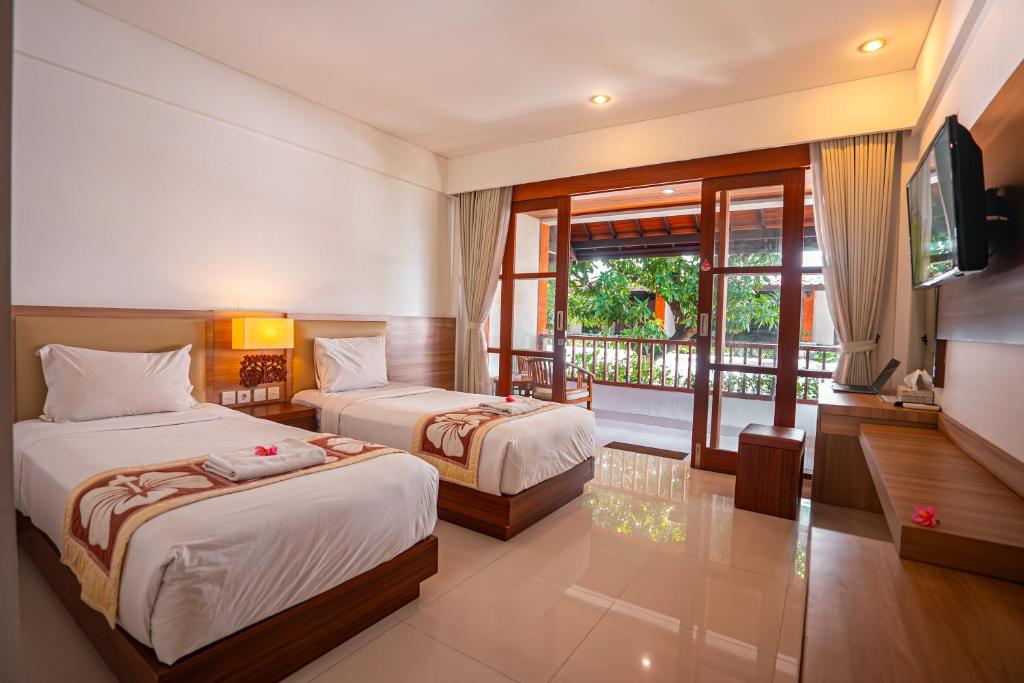 Postel nebo postele na pokoji v ubytování Bali Summer Hotel by Amerta