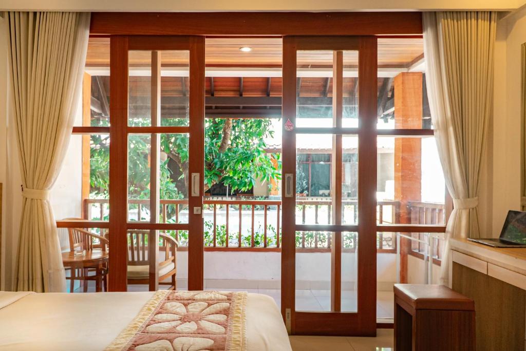 Postel nebo postele na pokoji v ubytování Bali Summer Hotel by Amerta