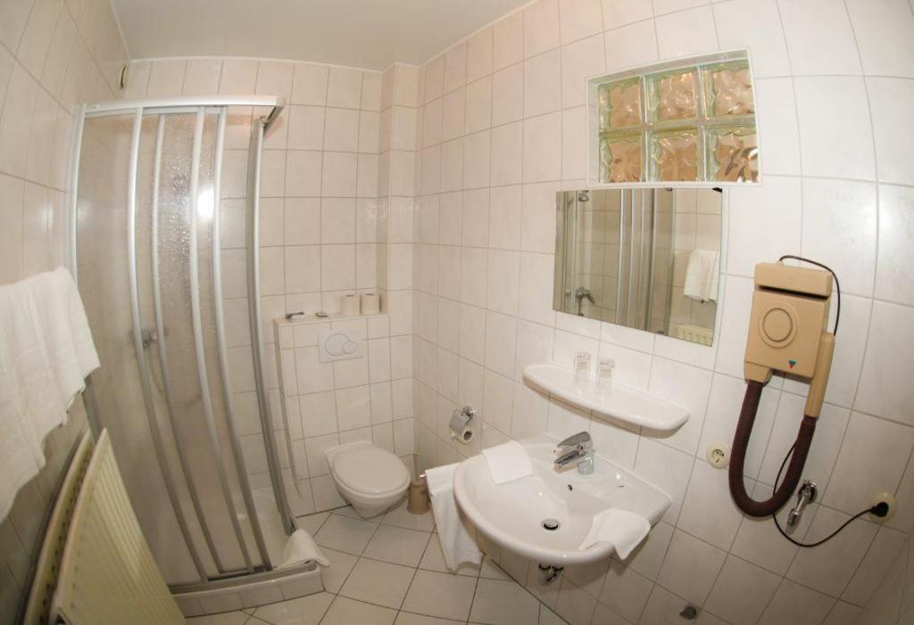 a bathroom with a sink and a shower and a toilet at Meyer Appartments in Beaufort