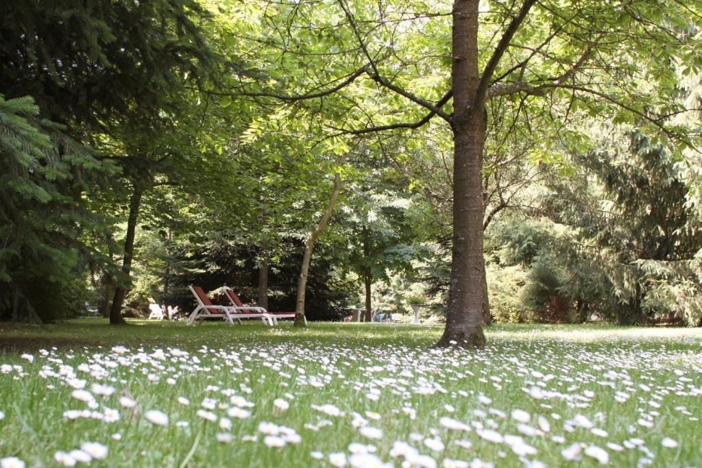 a park with a bench and flowers in the grass at Meyer Appartments in Beaufort