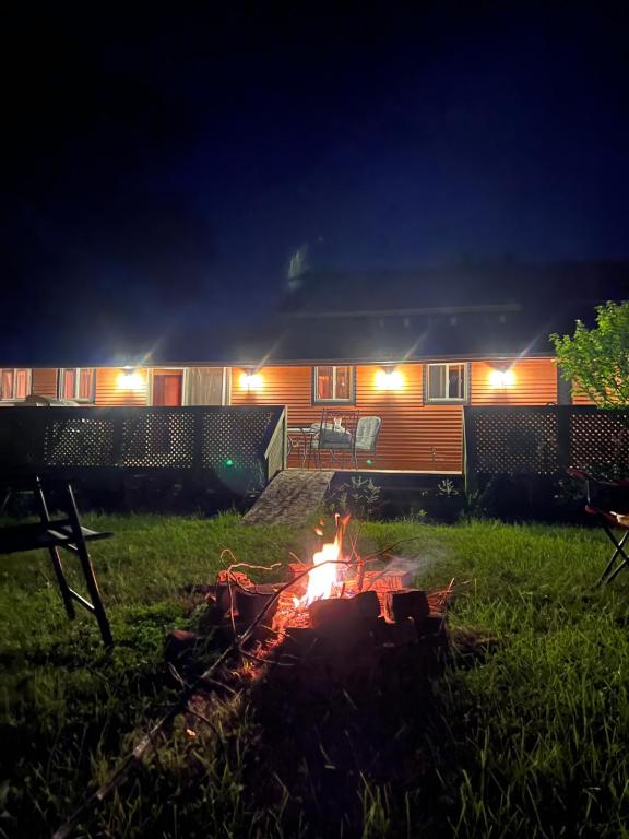 a campfire in front of a house at night at Cottage in Crystal Beach in Fort Erie