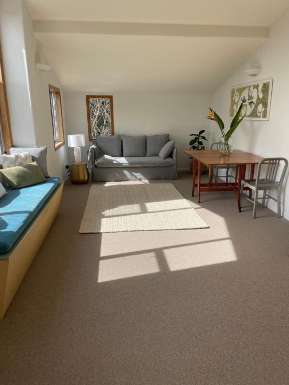 a living room with a couch and a table at Kaingarua Retreat in Kerikeri