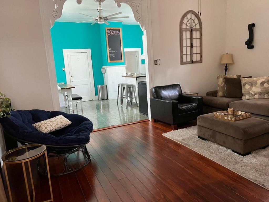 a living room with a couch and a table at Central City Charm in New Orleans