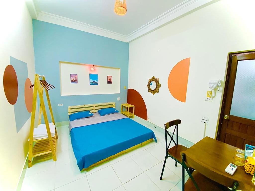 a bedroom with a bed and a table in it at Lion Homestay in Ninh Binh